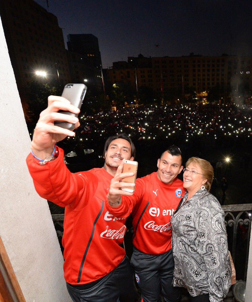 Mauricio Pinilla y Gary Medel se toman una "selfie" con la Presidenta Bachelet. Foto: Presidencia de la República.